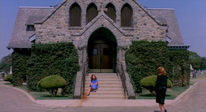 Nancy sits on the steps of the chapel as her mother (Ronee Blakley) approaches. Screenshot via New Line Cinema.