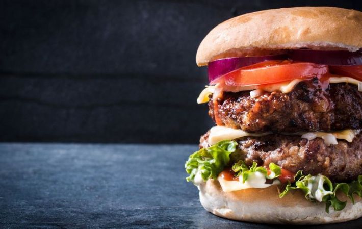 A double Colossal burger with red onion, lettuce, tomato, and cheese, from Made Burgers in Lawndale.