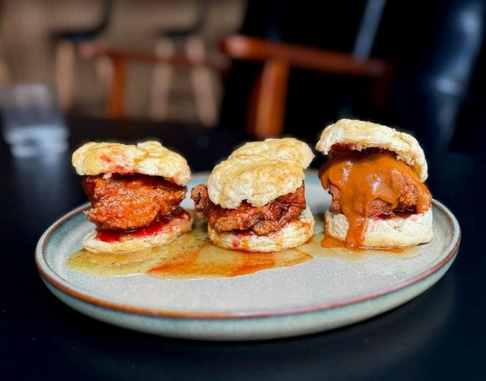 3 chicken biscuit sliders with miso honey butter glaze, and sauces including yuzu lemon pepper, honey sriracha, and wasabi buffalo.