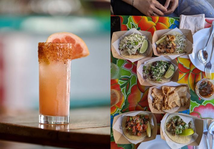 a table full of tacos next to a grapefruit cocktail.