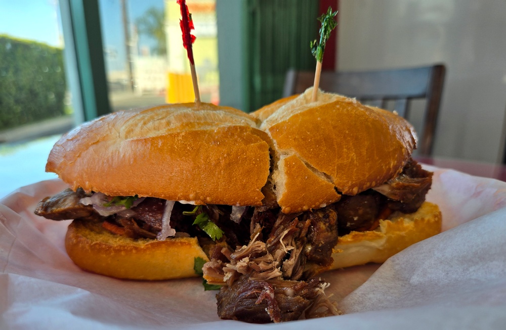 A Peruvian chicharron sandwich on Italian bread sourced in Upland.