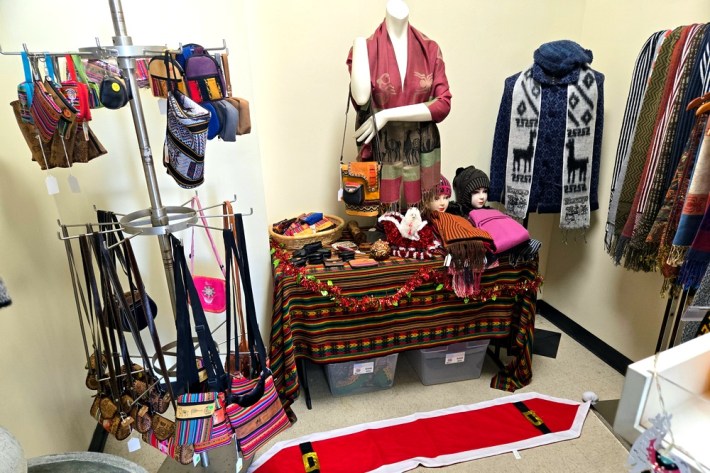 Peruvian textiles in a room, including purses, bags, and shawls