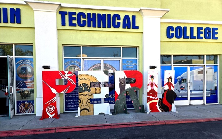 A Peru sign in front of Dolphin Technical College, the family's trucking school.