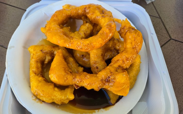 Peruvian picarones on a plate with syrup