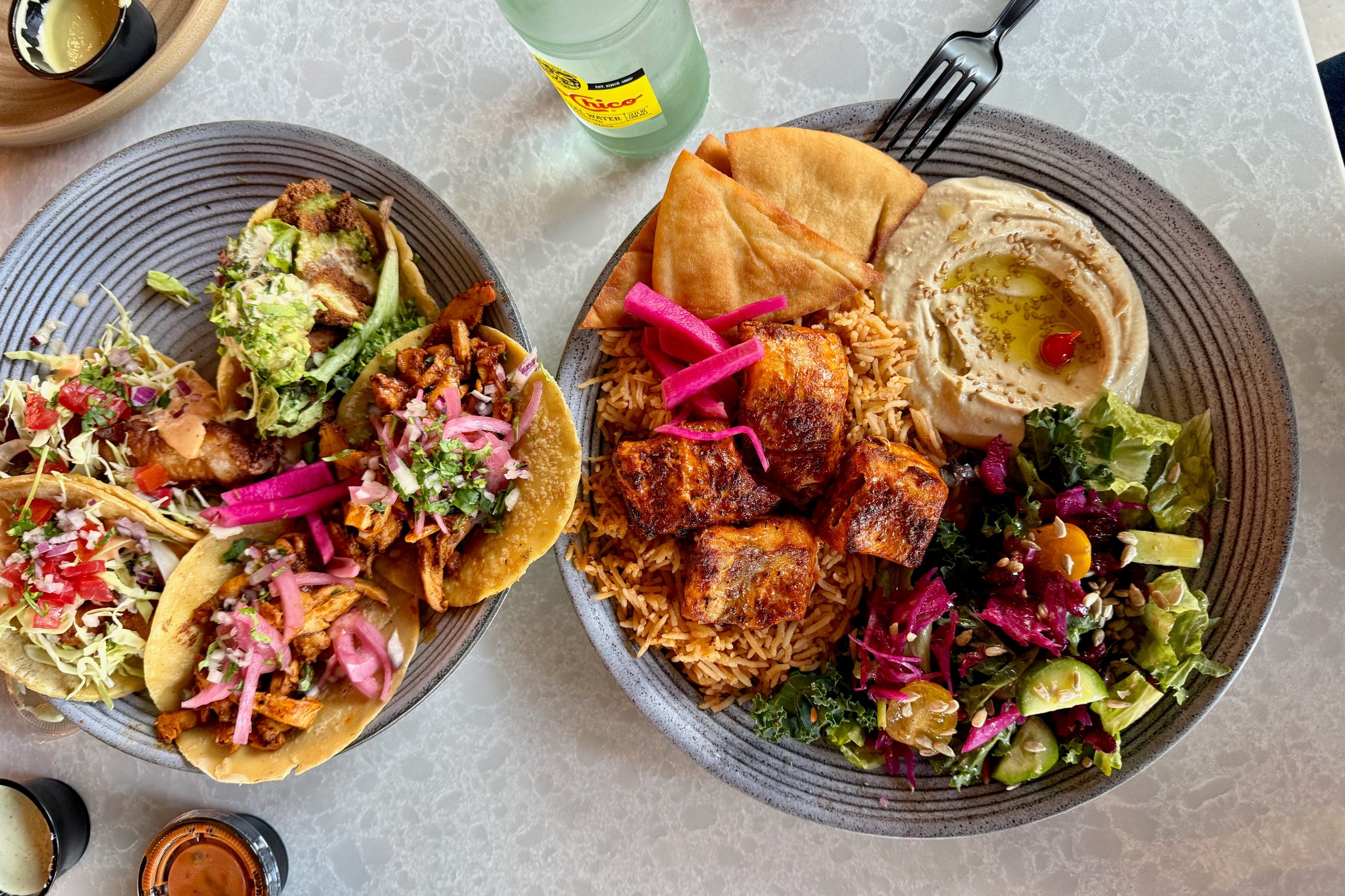 Salmon kabob plate and falafel, fish, and chicken shawarma tacos at Almaya. Photo by Javier Cabral for L.A. TACO.