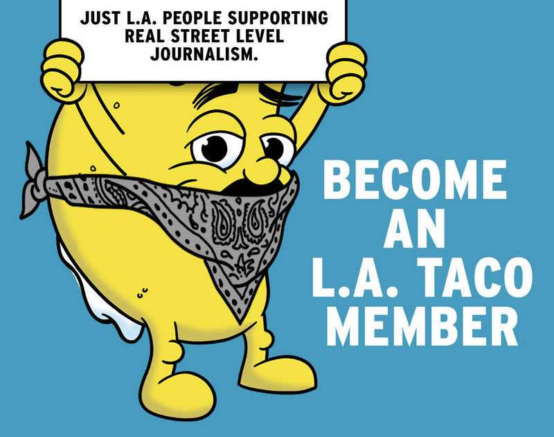 L.A. TACO's world-famous Tacoman, bandannaed-up and holding a sign that says AI Algorithims Billionaires, which are all crossed out