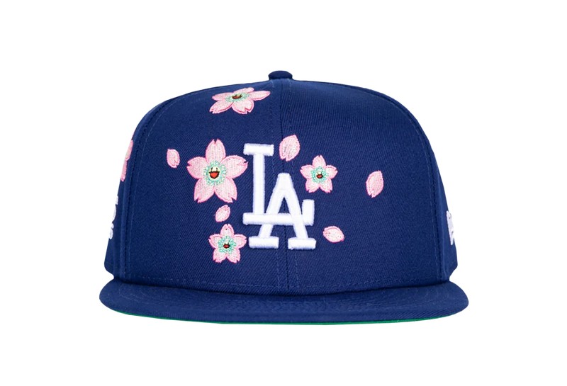 A blue Dodgers hat with pink flowers with smiley faces by Takashi Murakami.