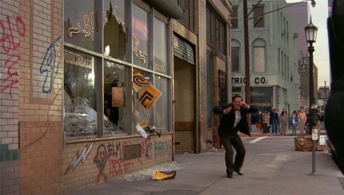 Mr. Sweetchuck (Tim Kazurinsky) abandons his lighting store as the new recruits bungle the response to a reported robbery, in a screenshot from Police Academy 2.