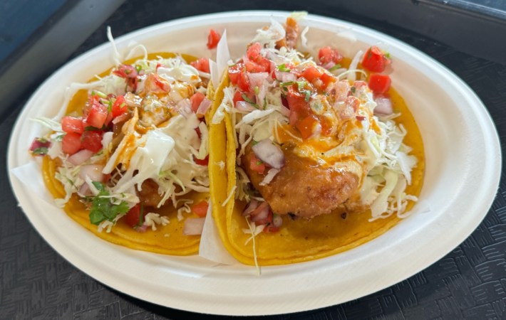 Ensenada Surf and Turf battered fish tacos topped with shredded lettuce, pico, and their special sauce.