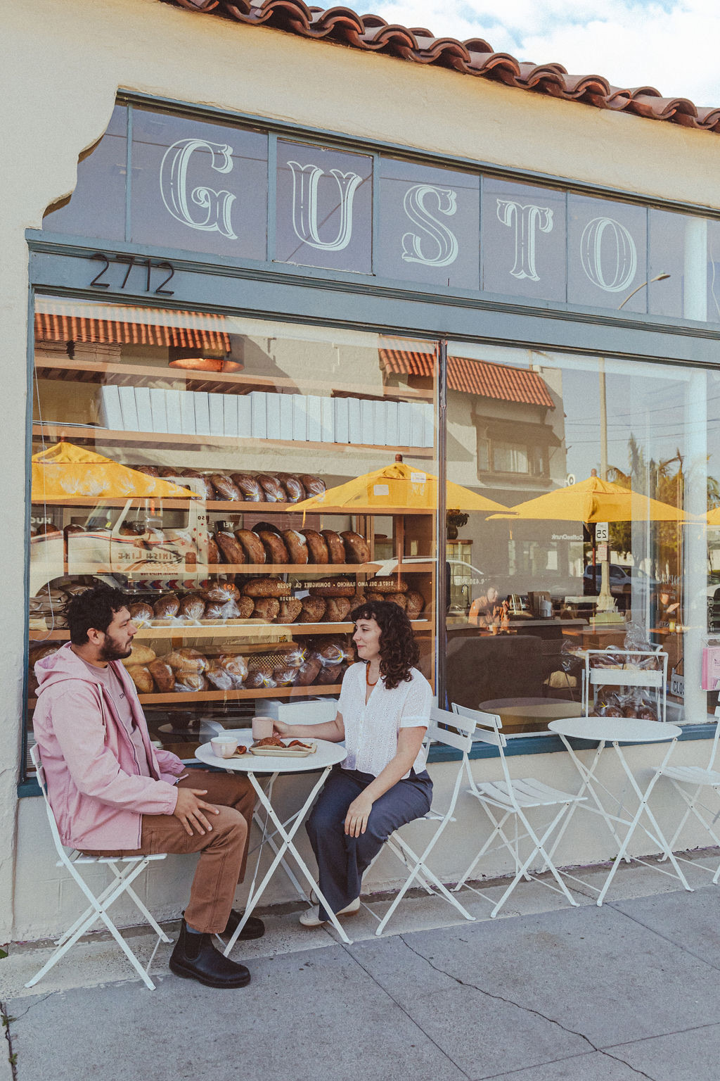 Arturo Enciso and Ana Salatino sit in front of their Gusto Bread in Long Beach.
