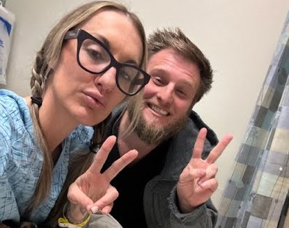 Alex Smith and her husband Jason Maccani pose for a photo.