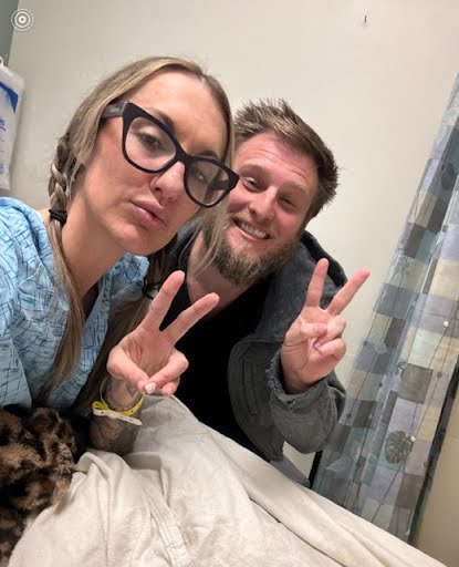 Alex Smith and her husband Jason Maccani pose for a photo.