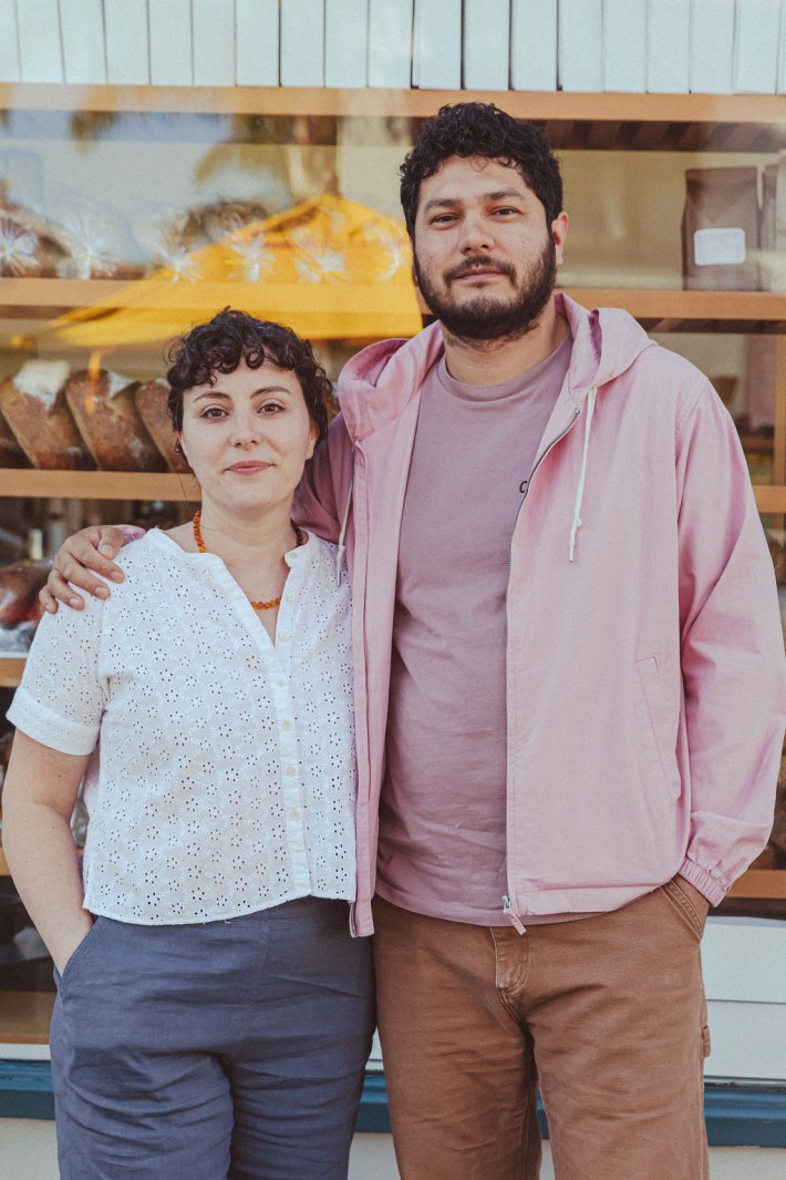 Ana Salatino and Arturo Enciso standing in front of their Gusto Bakery.