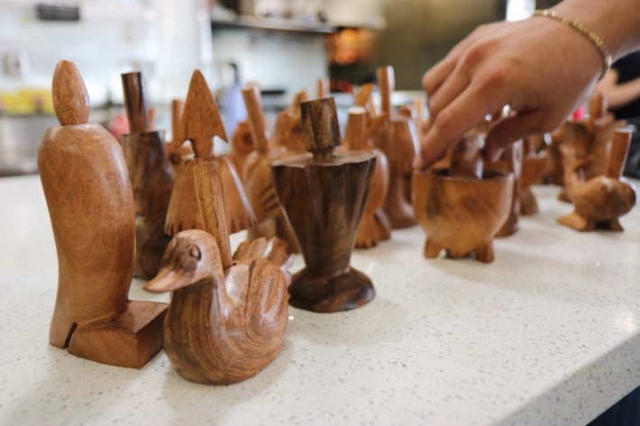 Wooden chili crushers or grinders commonly known as Chiltepineros lined on the counter. They are used specifically to grind chile piquín.