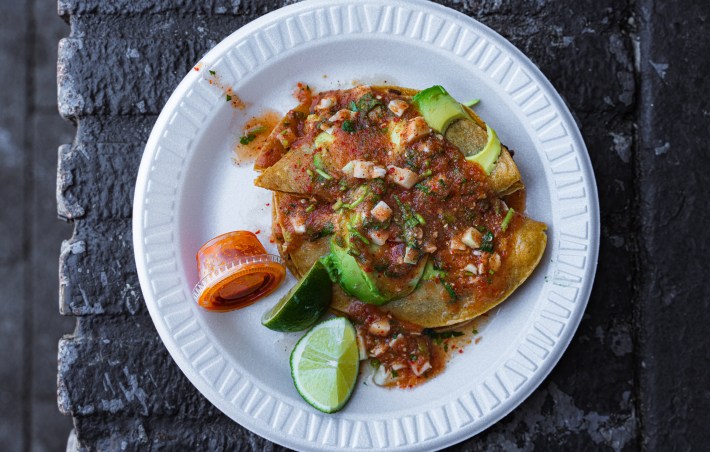 Mariscos Jalisco Taco served on a white plate with their special sauce poured over it.