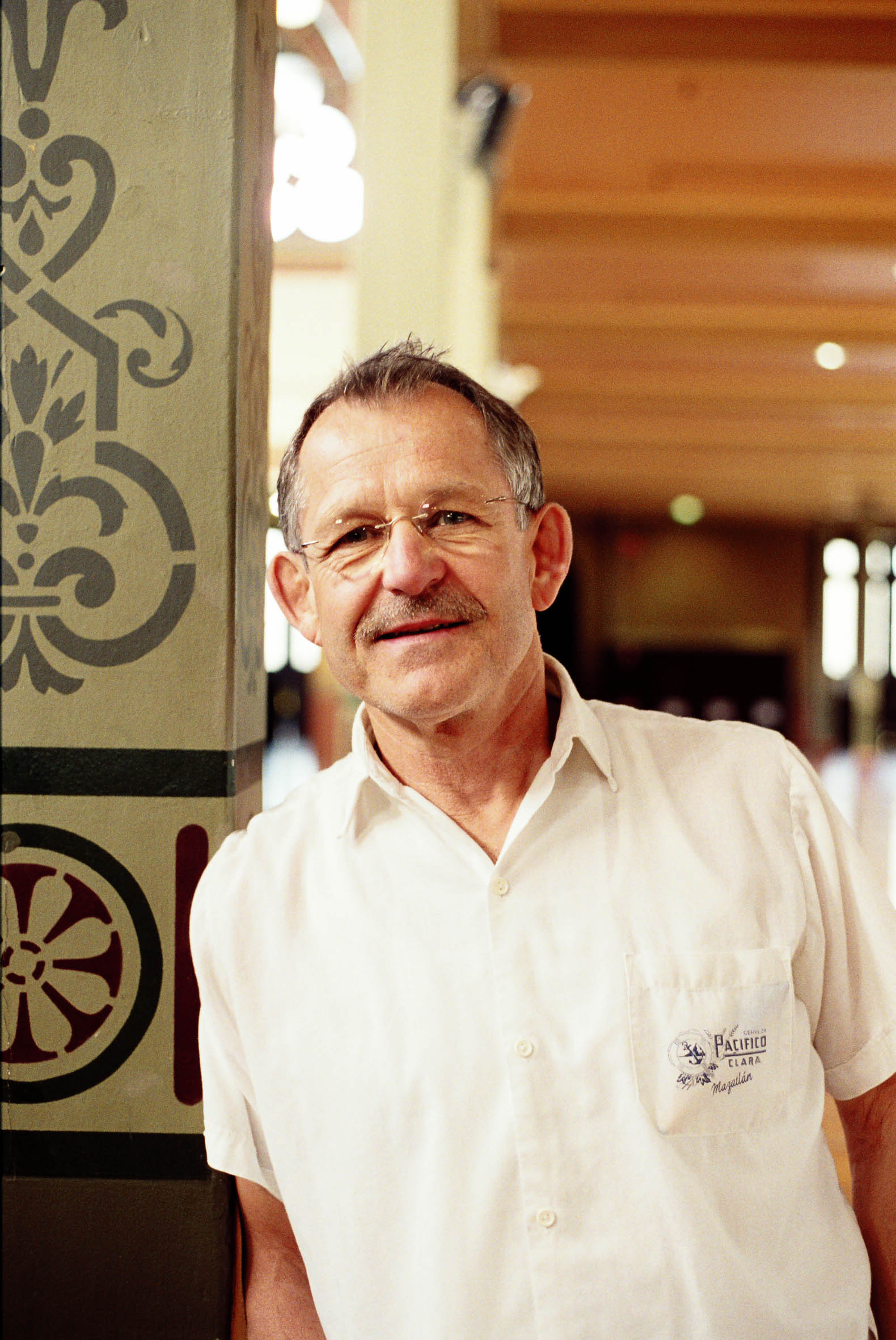 Tomas Estes posing next to a doorframe.