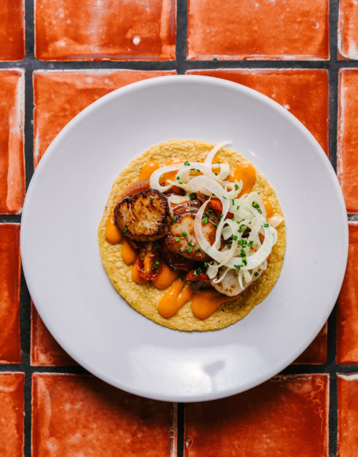 The scallop Taco from Holbox is pan seared and topped with chile x'catic sauce, caramelized onions, tomato & marinated fennel.