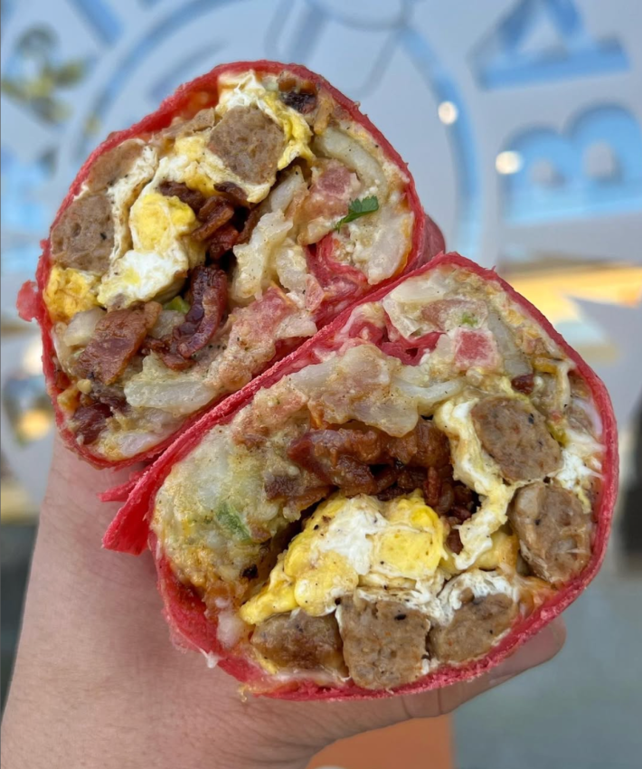 The red tortilla burrito is filled to the brim with a cheesy egg mixture, your choice of bacon and/or large, juicy cuts of steak, or sausage, freshly cut cajun fries, and their own pico de gallo and spicy mayo.