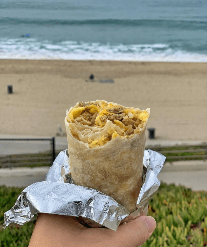Breakfast burrito with a beach background