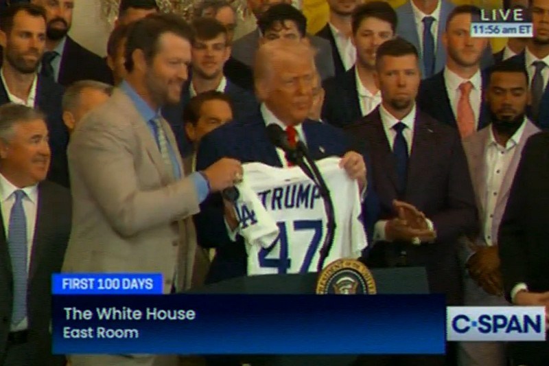 Dodgers pitcher Clayton Kershaw presents Donald Trump with his own named Dodgers jersey in a ceremony at The White House, flanked by other members of the Dodgers team and organization. Screenshot via CSPAN.