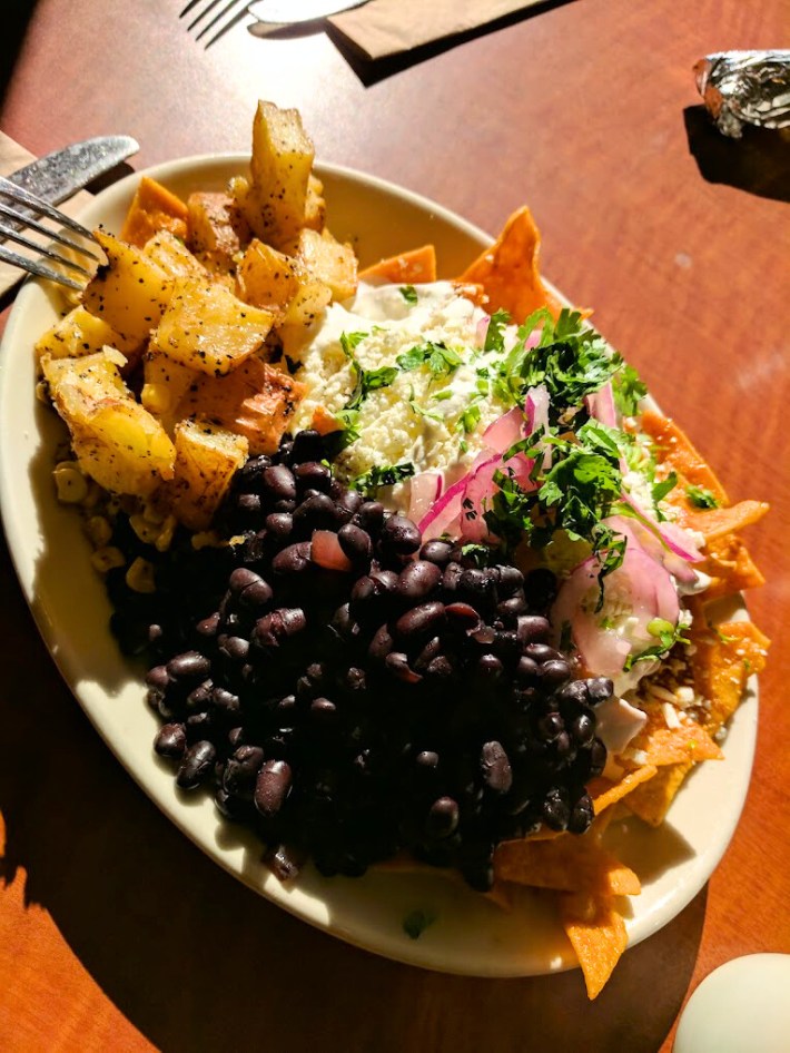 chilaquiles rojos with black beans and potatoes.