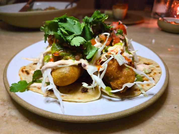 Black cod is battered and fried to a gorgeous, golden tan, then placed on corn tortillas sourced from a local mom-and-pop, and dressed with salsa roja, chipotle aioli, and cabbage.