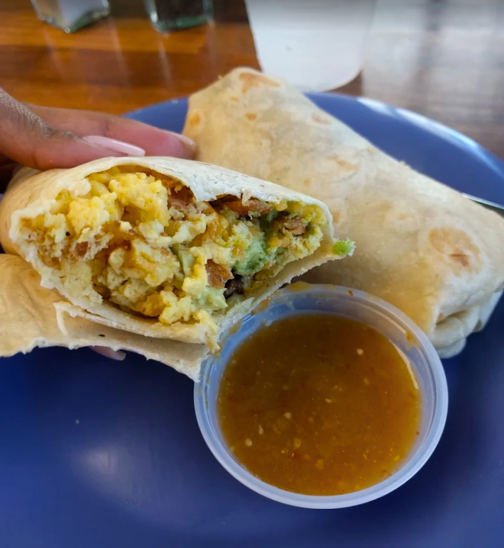 two breakfast burrito with bacon egg and cheese and avocado.
