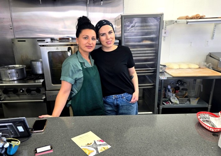 Two women from Georgia stand close together at their restaurant, Saqartvelo in Van Nuys.