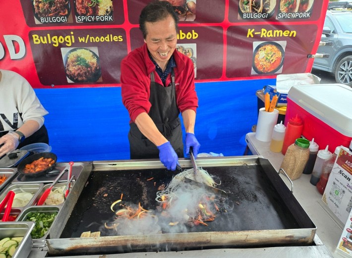 Ken Lee, laughing, by the side of his wife, Savannah, as he cooks up glass noodles at Assa. Photo by Hadley Tomicki.