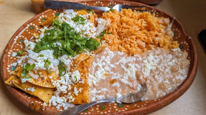 chilaquiles rojos, with beans, cheese, and rice.