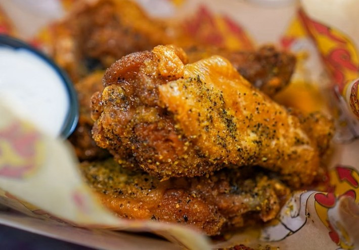 A close-up shot of a lemon-pepper wing-size chicken drumstick
