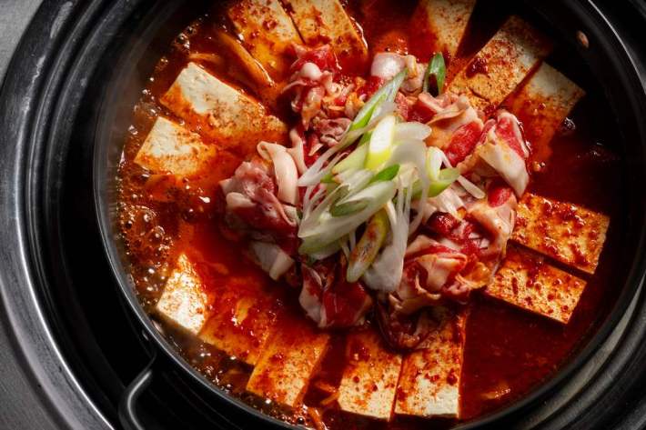 A red pot of beef belly-braised tofu at Baekjeong in Koreatown.