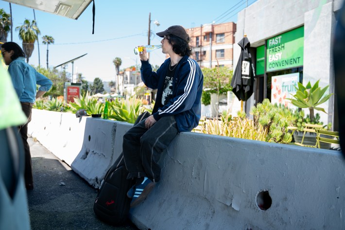 Markusiano drinking a Topo Chico on a 95-degree afternoon.
