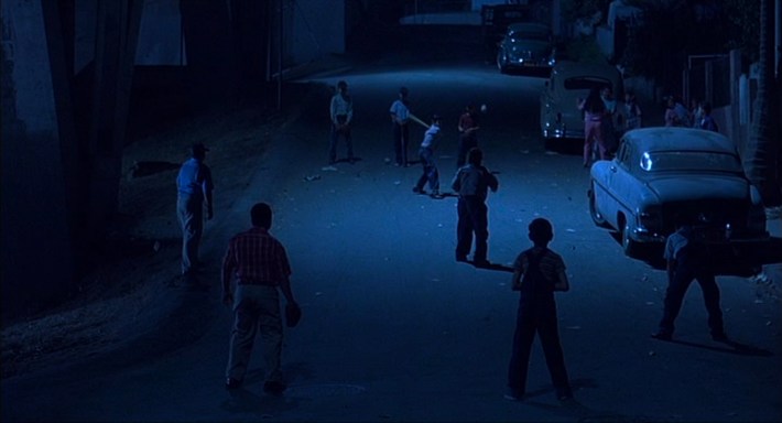 Neighborhood kids playing baseball prior to Chucho’s death. Screenshot via New Line Cinema.