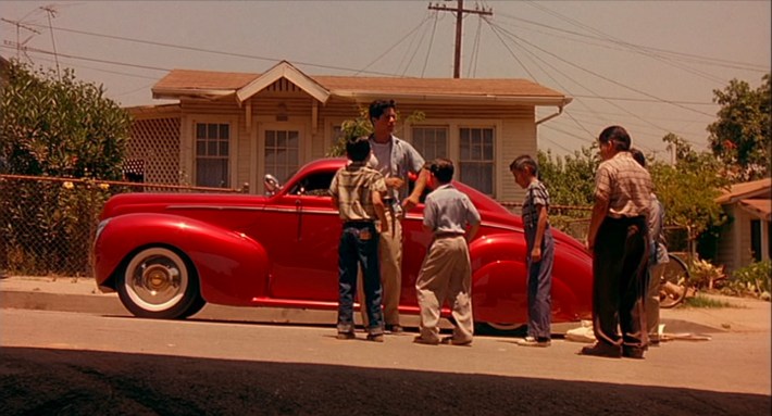 Chucho (Esai Morales) teaches the neighborhood kids to mambo. Screenshot via New Line Cinema.