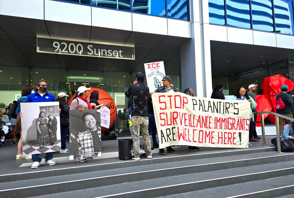 Protestors in front of 9200 Sunset Blvd, holding up signs