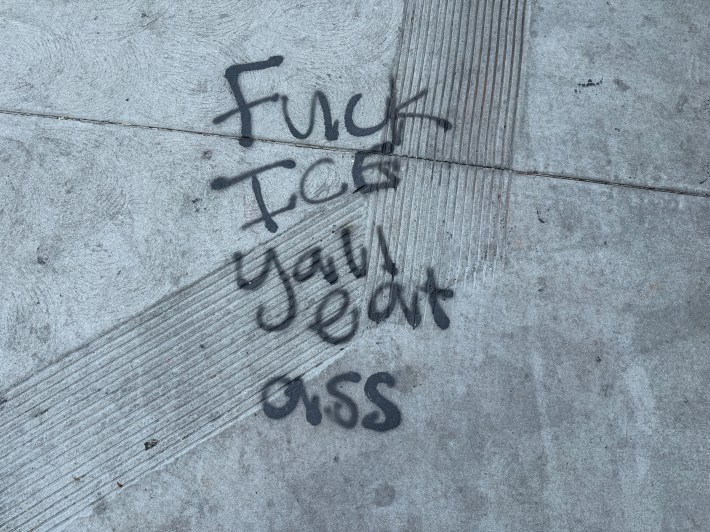 a spray-painted message that says "Fuck Ice Yall Eat Ass"