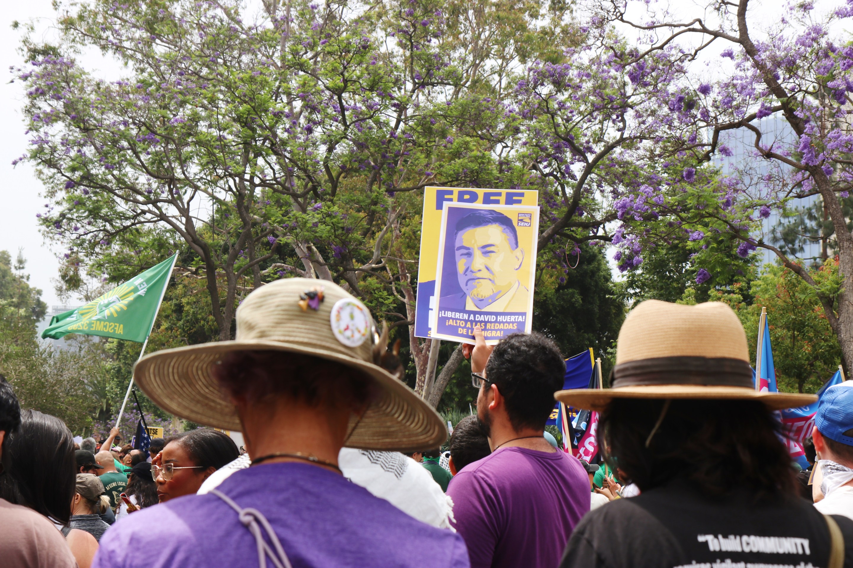 Protests signs being held up showing the face of union leader David Huerta