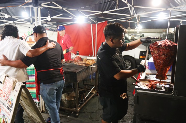 young taquero spins trompo