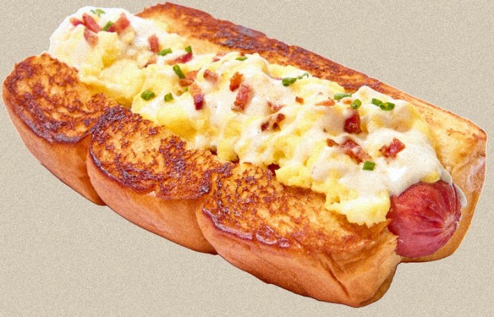 An omelet-topped hot dog with bacon bits at Bomb Hot Dog.