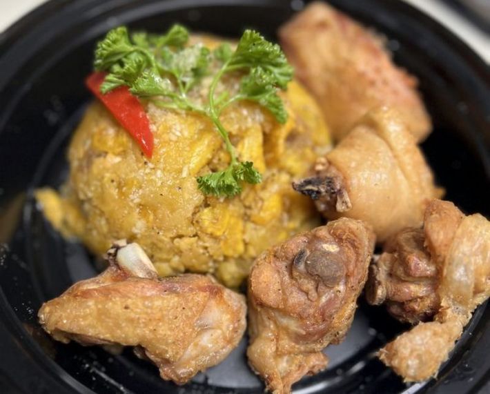 3 pieces of fried chicken beside a scoop of mofongo