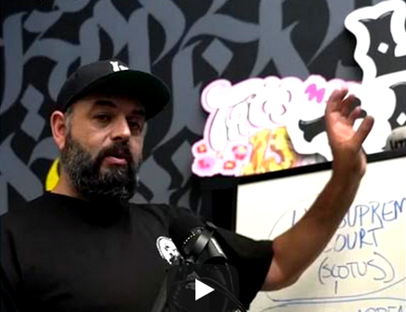 Man gestures at a white board.