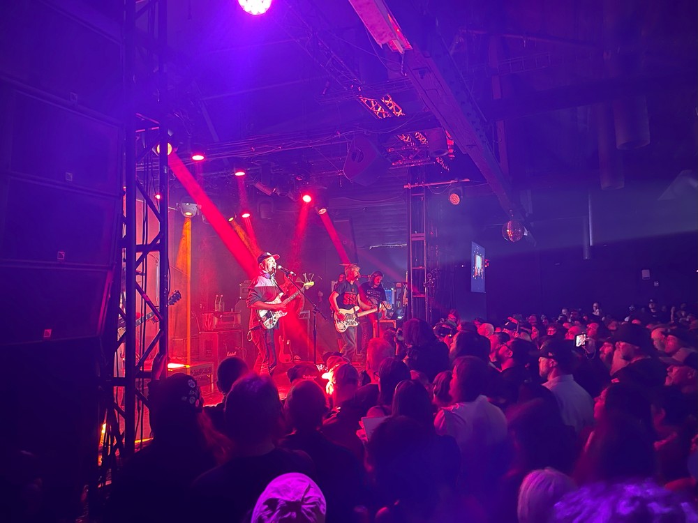 Guitarist Tom Morello under a red light onstage at Echoplex in Echo Park, with abassist to his left