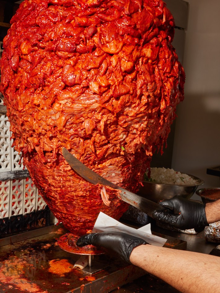 Marinated pork on a trompo (vertical spit) at Taquería Frontera . . .