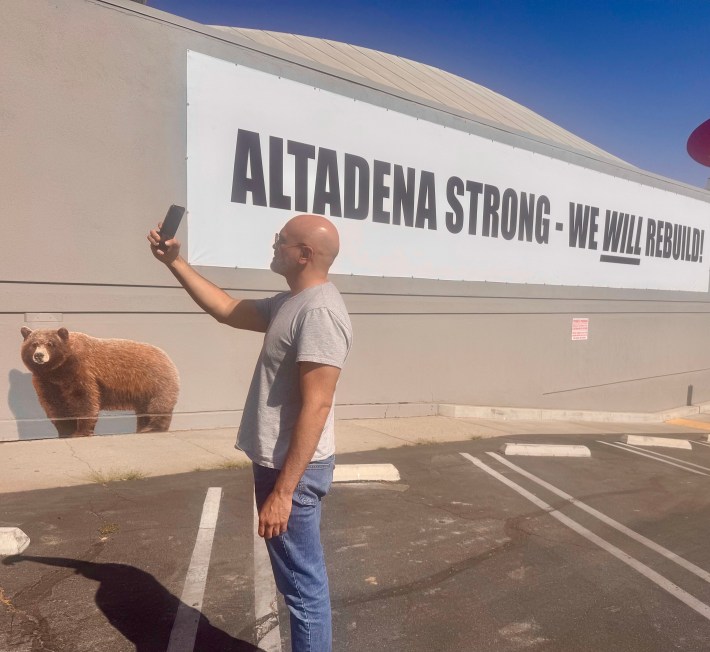Rafael Agustin standing in front of an Altadena Strong mural.
