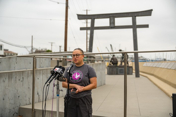 Joy Yamaguchi, a member of Nikkei Progressives, speaks at a press conference at Terminal Island on June 27. Photo by Nikkei Progressives.