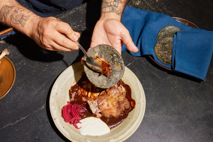 ‘A must-try for global travellers who love chasing both street food and high-end thrills’: Ponce prepares his award-winning duck confit taco.