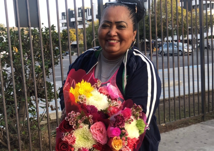Emma De Paz holding flowers. Photo via Emma's daughter.