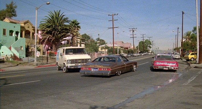 Cheech and Chong’s van is cut off by two lowriders. Screenshot via Universal Pictures.