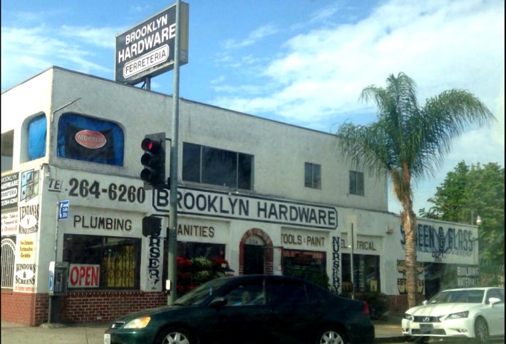 A white two-story building advertising Brooklyn Hardware